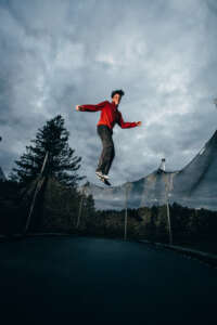 Maine highschool senior portrait by kerry struble, NH portrait artist. Dramatic trampoline senior photo session.